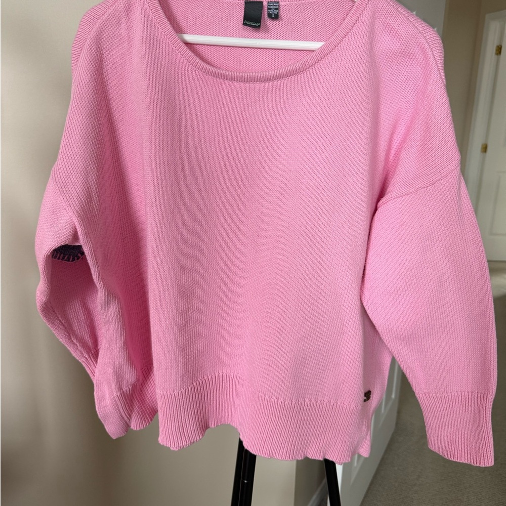 Women's Pink Sweater with blue hearts on back of sleeves.